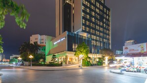 A modern hotel with a prominent 'MEN BAc HOTEL' sign, a glass facade, and a well-lit entrance area. - Bien Bac Hotel (Mong Cai)