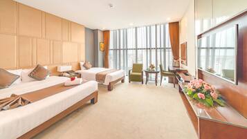 Deluxe Triple Room | Minibar, in-room safe, desk, blackout curtains