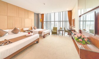 Deluxe Triple Room | Minibar, in-room safe, desk, blackout drapes