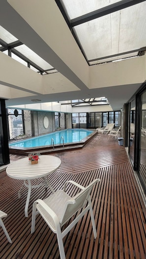 Outdoor pool, a heated pool, pool umbrellas, pool loungers
