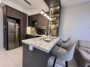 Design Apartment | Private kitchenette | Full-size fridge, stovetop, electric kettle, cookware/dishes/utensils - Design Haven Suite Subang by Icon Stay (Subang Jaya)