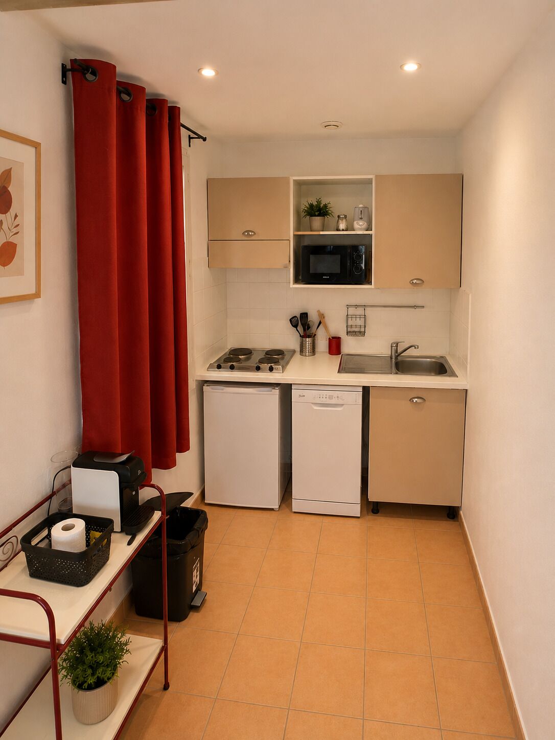 A compact kitchen with a microwave, sink, and small appliances.