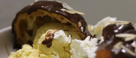 A dessert with ice cream, whipped cream, and chocolate sauce.