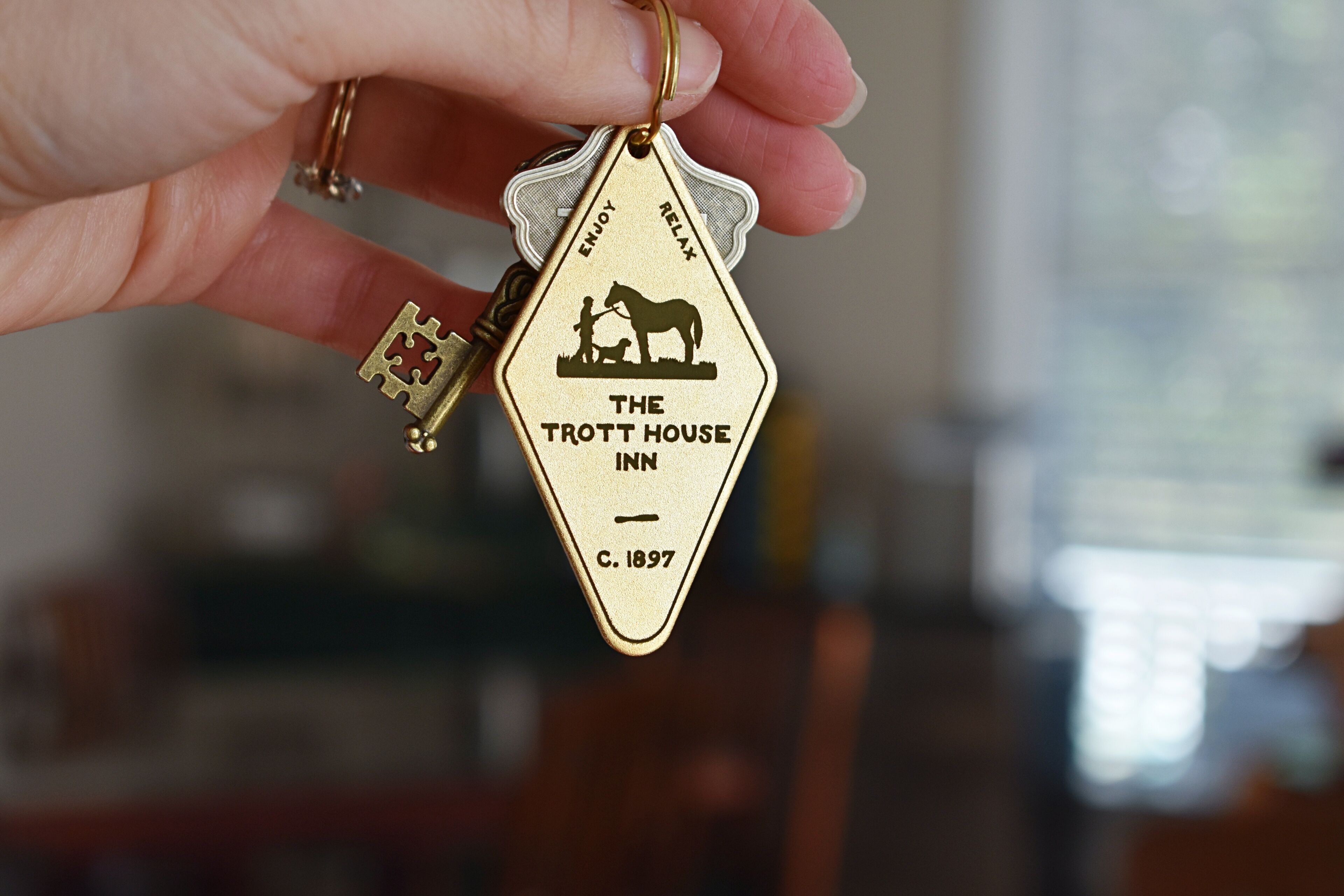 A keychain with a design for The Trott House Inn, established in 1897.