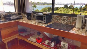 A kitchen with a view of a lake, a coffee maker, a toaster, and a sink. - The Fruit Tree Garden Bromeliad Suite (Arenal)