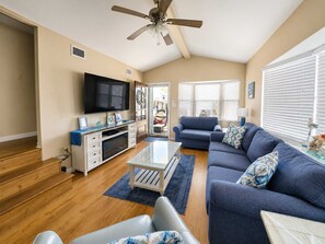 A living room with a flat-screen TV, a ceiling fan, a sofa, and a coffee table. - 183 Marlin Dr.  Newly Updated & Adorable! 3 Bedrooms -  2.5 Bathrooms (Panama City Beach)