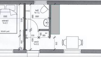 Plano de planta que muestra un dormitorio, un baño y un comedor.