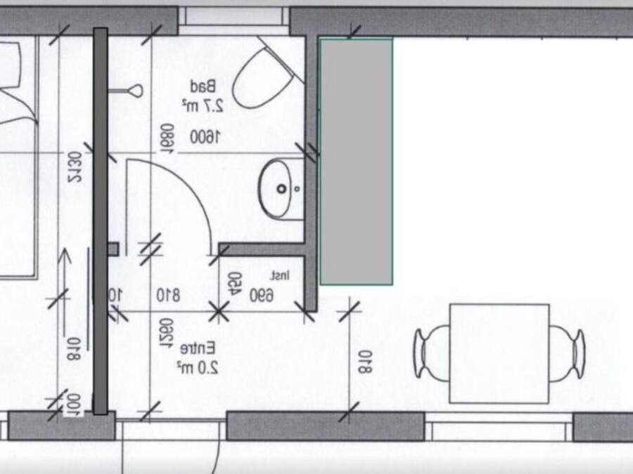 A floor plan with a bedroom, bathroom, and dining area.