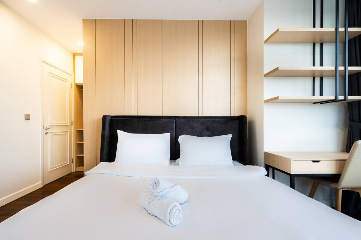 Ein Hotelzimmer mit einem großen Bett, einem Schreibtisch und einem Kleiderschrank.
