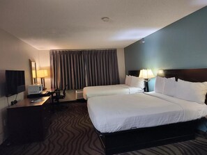 A hotel room with two beds, a desk with a computer, a TV, and a window with curtains. - Baymont Inn & Suites by Wyndham Lincoln NE (Lincoln)