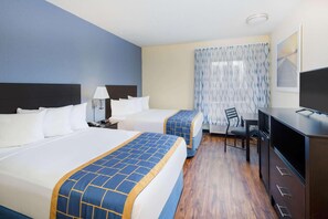 A hotel room with two beds, a desk, a chair, a television, and a window with curtains. - Days Inn by Wyndham Macon I-75 North (Macon)