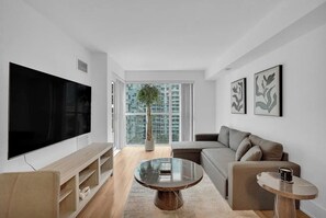 Comfort Condo | Living area | 55-inch Smart TV with digital channels, Netflix, streaming services - Waterfront Cove Hotel (Toronto)