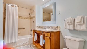 A bathroom with a shower, a bathtub, a vanity with a mirror, and a toilet. - 𝐅𝐢𝐧𝐝𝐢𝐧𝐠 𝐌𝐞𝐢𝐥𝐢’𝐬 Beach Fun Waiohai Club Resort + Amenities (Koloa)