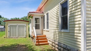 A house with a front porch, a garage, and a window. - Cozy and charming. Your home away from home in the heart of Viroqua. (Viroqua)