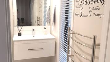 Shower, hair dryer, towels, soap