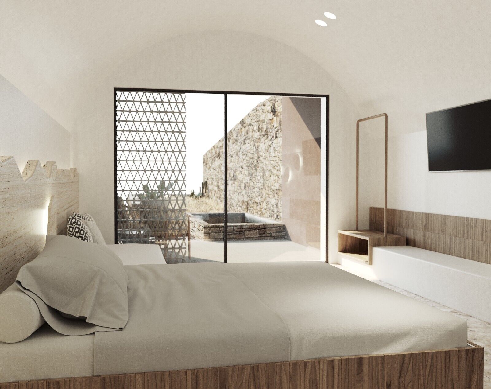 Un dormitorio moderno con una cama grande, cabecera de madera, puerta corrediza de vidrio que da a un patio y un televisor montado en la pared.