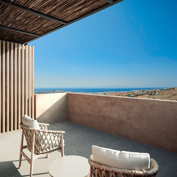 A balcony with wicker furniture and a view of the sea. - Sun Aeriko (Tinos)