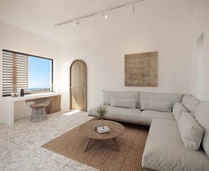 A modern living room with a large window, a wooden door, a beige sofa, a round wooden coffee table, and a woven rug. - Sun Aeriko (Tinos)
