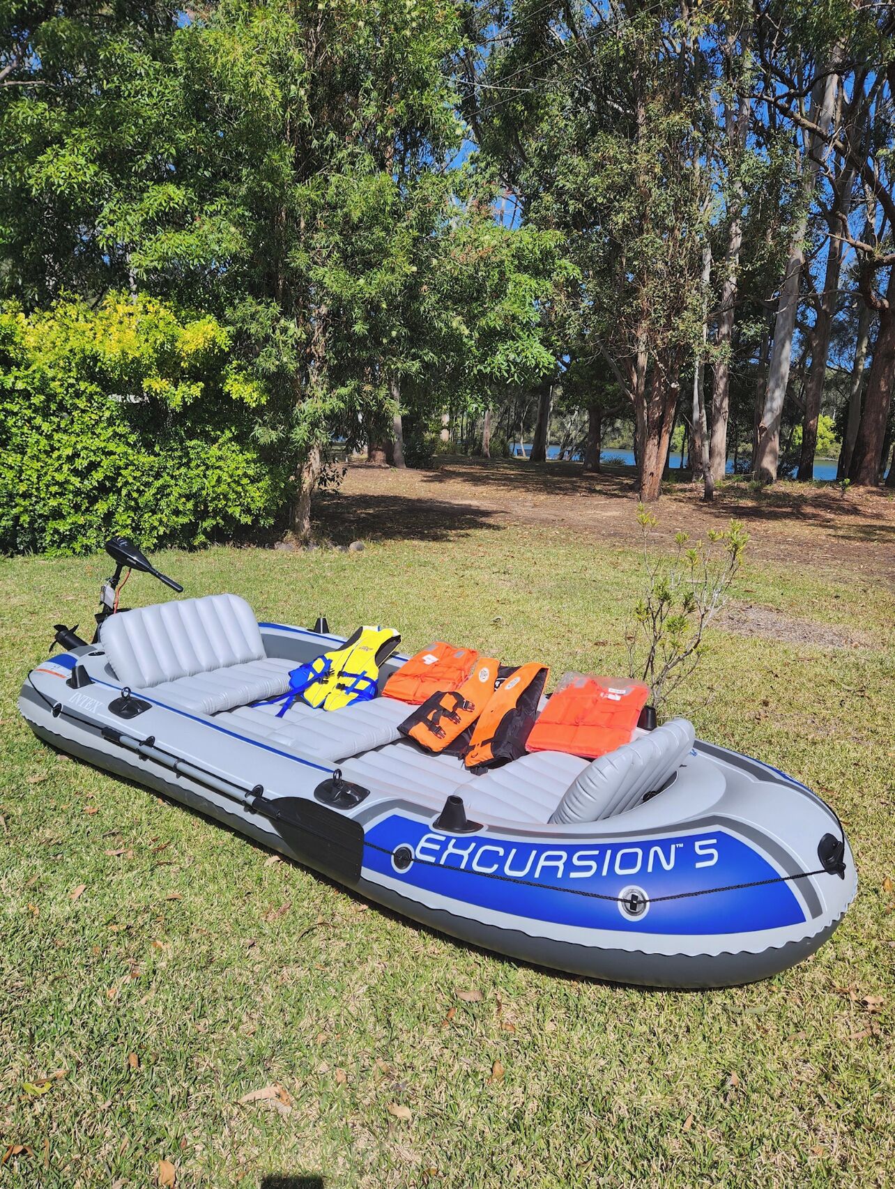 An inflatable boat named 'Excursion 5' with seating and life jackets.