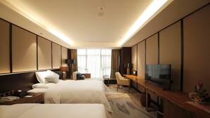 A hotel room with two beds, a desk, a television, and a large window with curtains. - Gleetour Hotel Guizhou  (Qiandongnan)