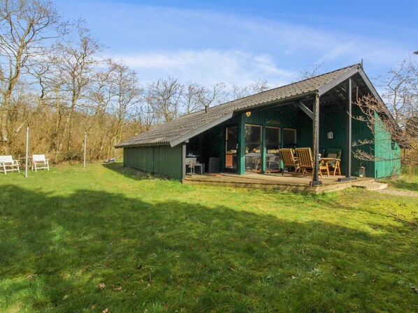 Guests can relax on the porch with a table and chairs.