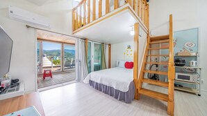 A bedroom with a bed, a wooden ladder, a kitchenette, and a balcony with a view. - Gyeongju Star spa Pension (Gyeongju)