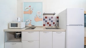A kitchen with a microwave, coffee maker, and a refrigerator. - Gyeongju Star spa Pension (Gyeongju)