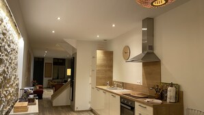 A modern kitchen with a wooden countertop, stainless steel appliances, and a built-in oven. - By the ramparts, house with pool & stunning view, guesthouse La Trivala (Carcassonne)