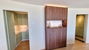 A modern kitchen with built-in cabinets and a wooden accent wall.