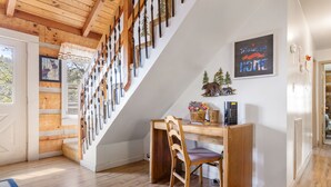 A wooden staircase with a white wall and a desk with a chair. - Mountain Vintage (Sevierville)