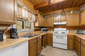 Enjoy cooking in this well-equipped kitchen with a coffee maker, microwave, oven, and toaster.