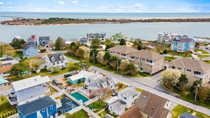 A residential area with houses, a swimming pool, and a view of the water. - Four Bedroom West OC Home with Pool and Hot Tub (Ocean City)