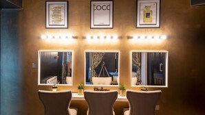 A room with three chairs, a desk, and three illuminated mirrors. - Tudor House - Hot Tubs Chester City Sleeps 30 (Cheshire West and Chester)