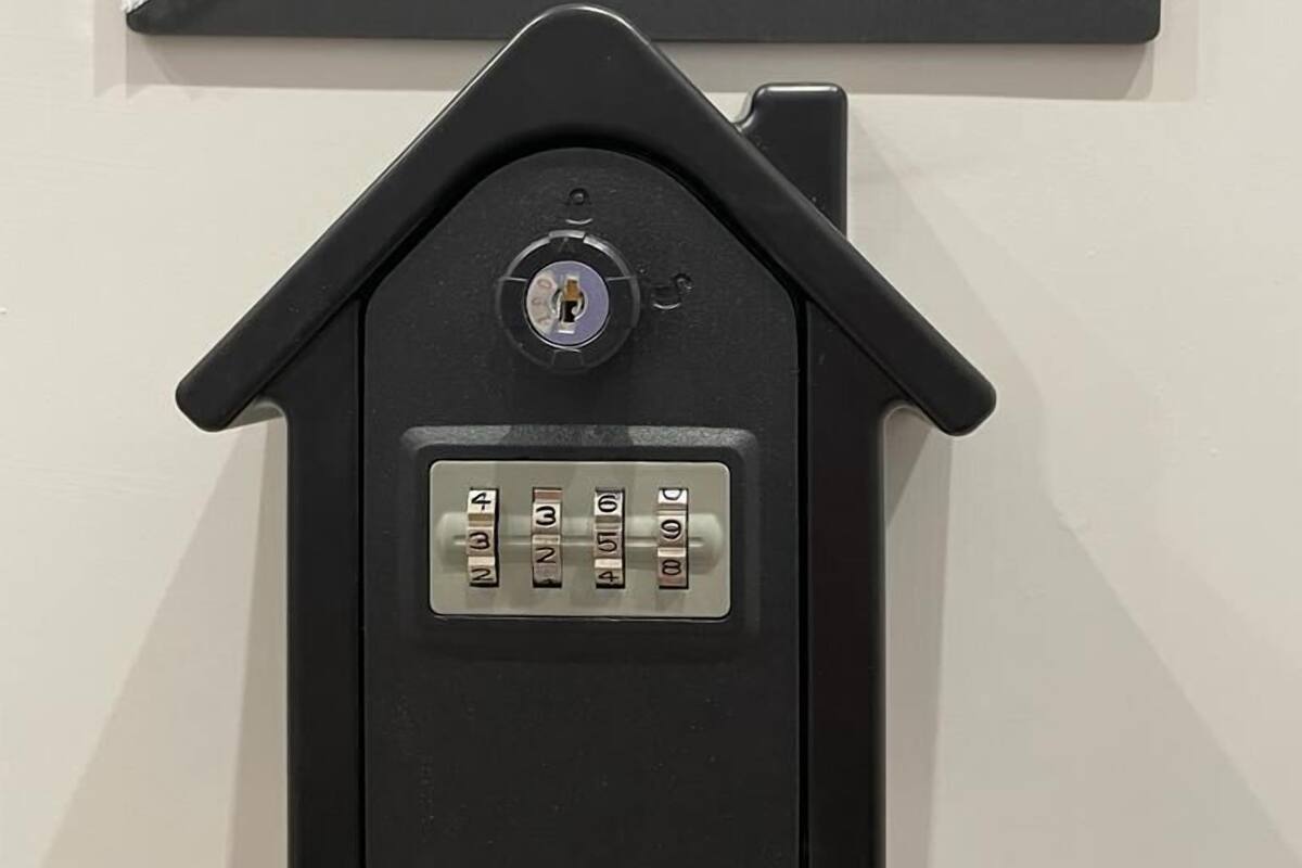 A house-shaped keypad with a sign above it that reads "ALMOND ROOM welcome!".