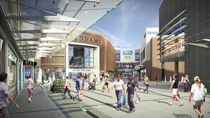 A modern shopping area with various stores including a Debenhams store, a Tesco, and a Next store. - The Maelor 2 Bedroomed Apartment |Central Wrexham (Wrexham)