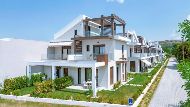 A modern multi-story residential building with balconies, large windows, and a well-maintained lawn. - Argilos & Argilos Deluxe Residential Complexes-Two - Bedroom Duplex with Garden (Kavala)
