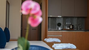 A modern hotel room with a bed, a bathroom, and a kitchenette. - New wave apart hotel (Batumi)