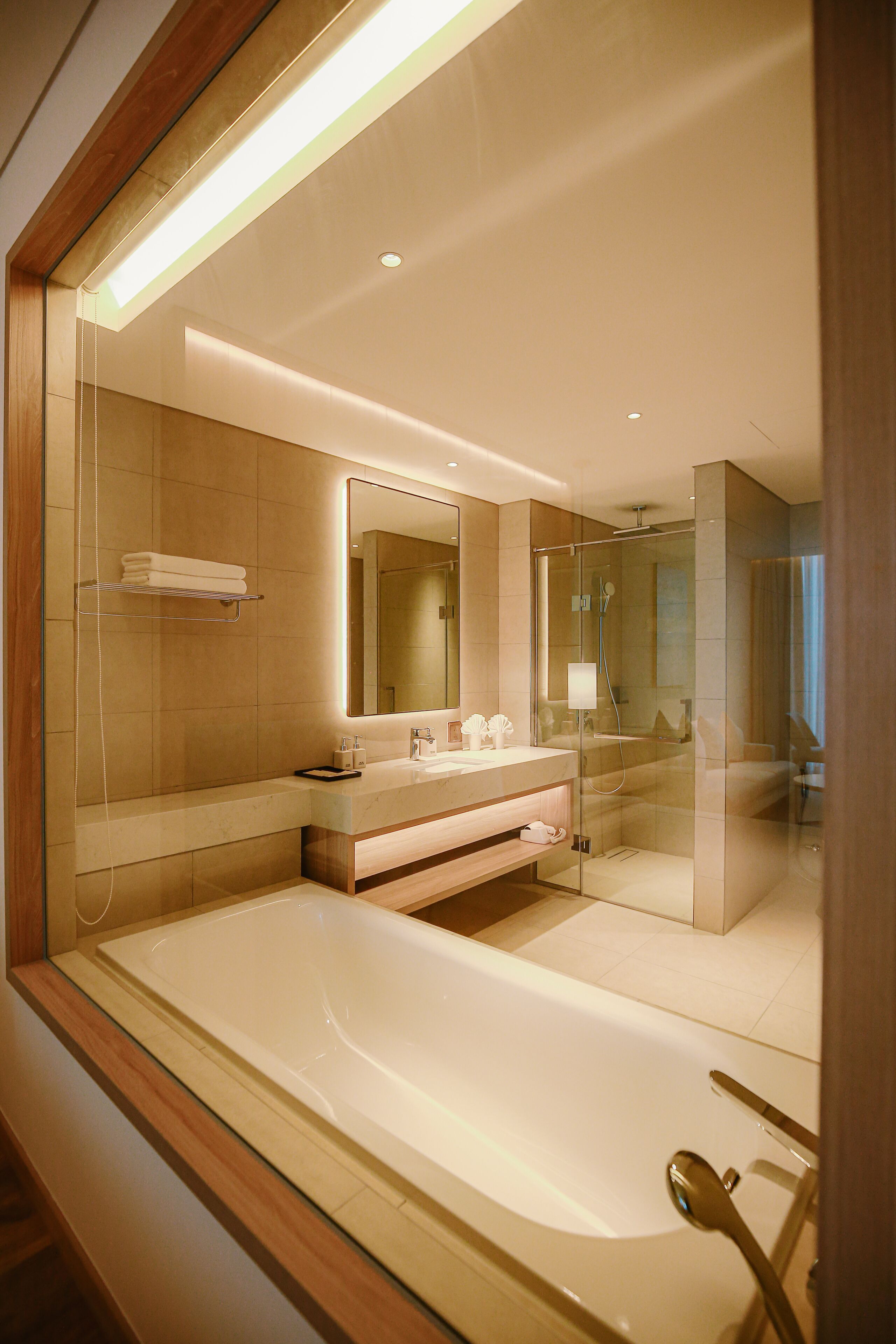 Deep-soaking bathtub, rainfall showerhead, designer toiletries
