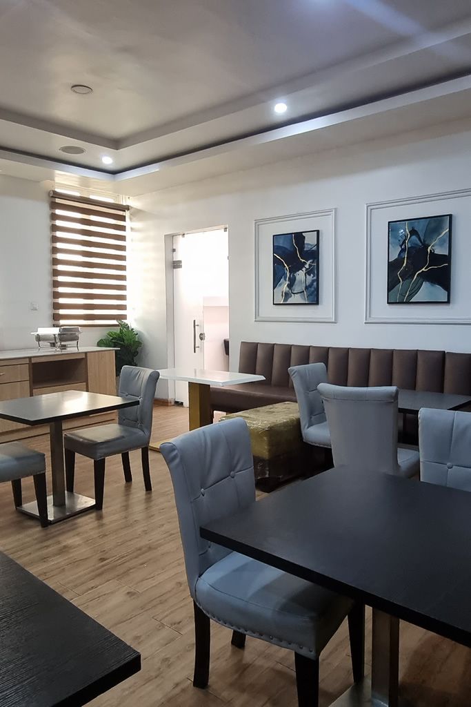 A modern interior with a dining area, seating, and artwork on the walls.