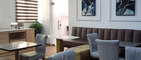 A modern interior with a dining area, seating, and artwork on the walls.