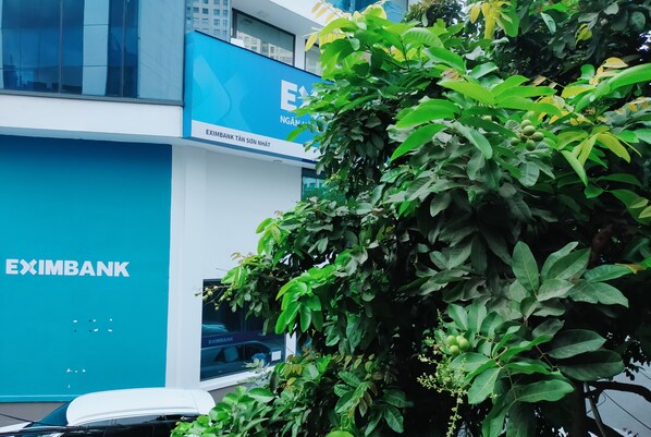 A modern building with a blue facade and the EXIMBANK logo. - Shusimi Boutique (Ho Chi Minh City)