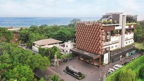 Un hôtel moderne doté d’une façade hexagonale originale, situé près d’un plan d’eau.