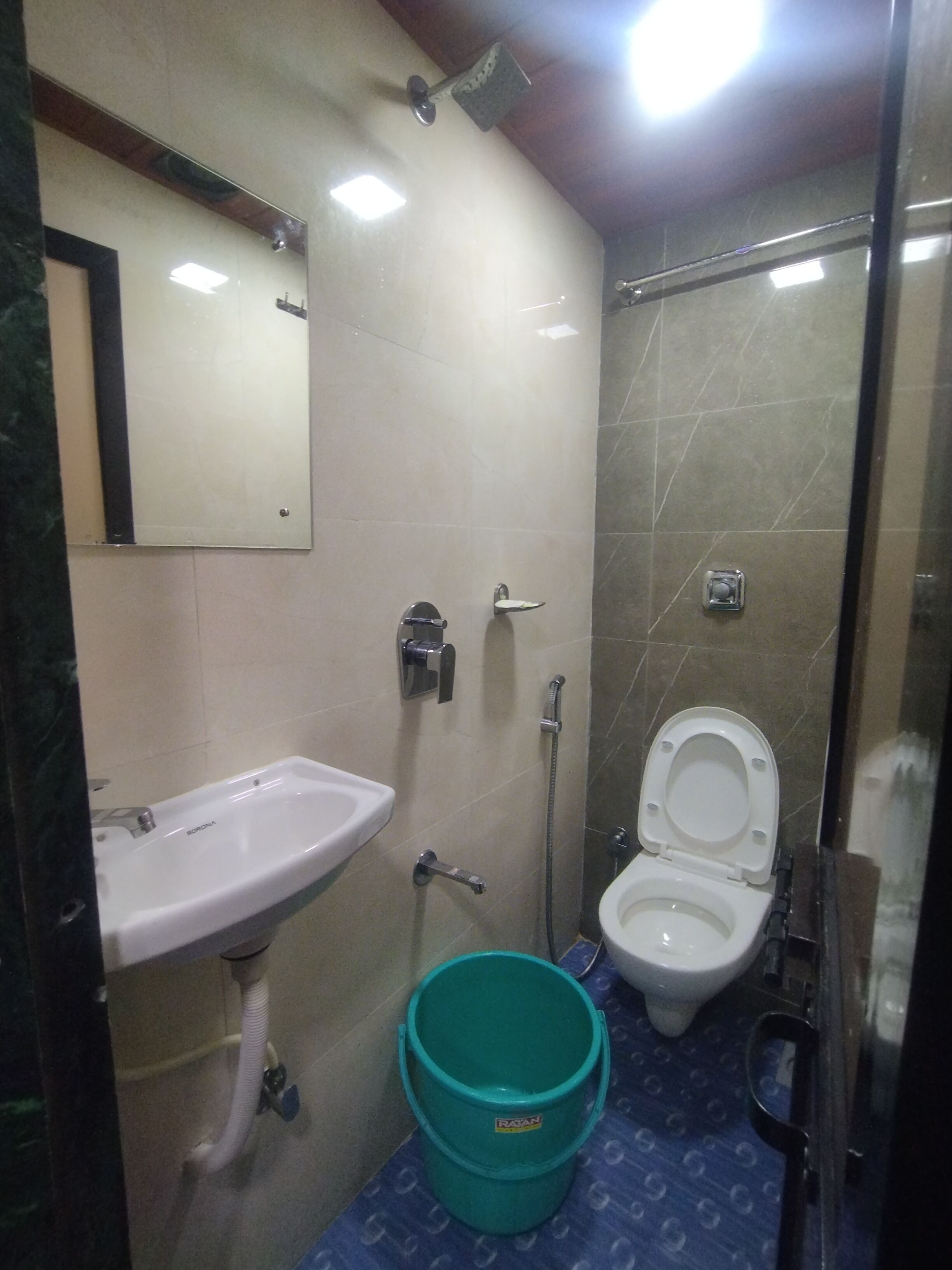 A small bathroom with a sink, toilet, and shower.