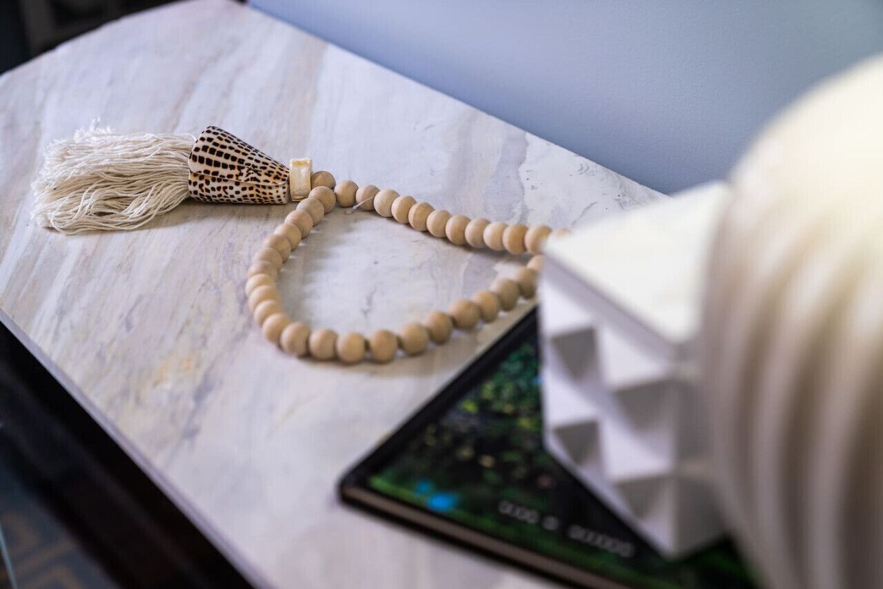 A marble surface with a wooden object and a device.