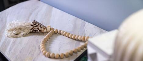A marble surface with a wooden object and a device.