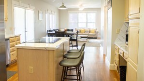 A spacious kitchen with a central island, bar stools, and a dining area with a sofa and chairs. - Large colonial style house in the most sought after area - Ballantyne.  (Charlotte)
