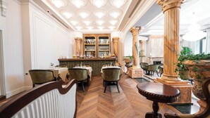 A hotel lobby with a bar area, wooden flooring, and classic furniture. - La Fe boutique Hotel Sarande (Sarandë)