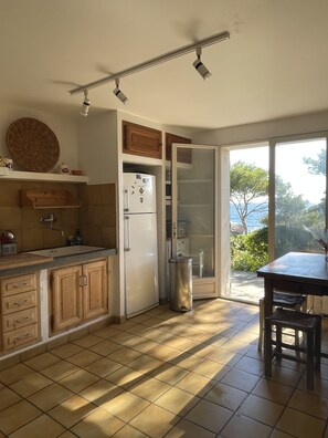 Enjoy a serene view from the kitchen window, where you can cook and dine in comfort.