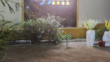 A paved entrance with a sign reading 'LA ROSELINE' and a wall with a window.