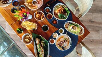 A dining table with various dishes, including a fish dish, salads, and sides.